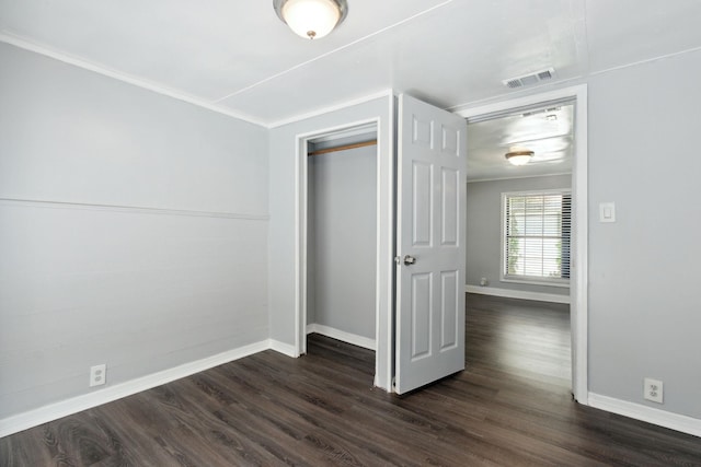 unfurnished bedroom featuring dark hardwood / wood-style floors and a closet