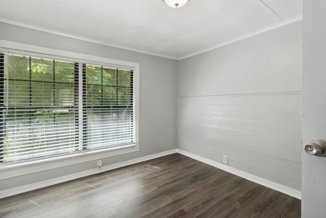 unfurnished room featuring ornamental molding and dark wood-type flooring