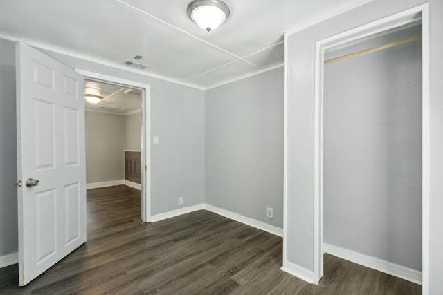 unfurnished bedroom with a closet and dark hardwood / wood-style flooring