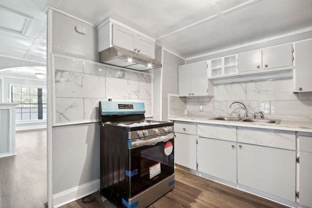 kitchen with white cabinetry, stainless steel range, sink, dark hardwood / wood-style flooring, and decorative backsplash