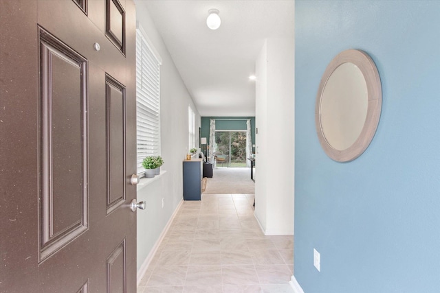 hallway featuring light tile patterned floors