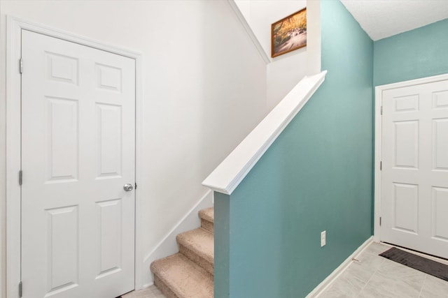 staircase with tile patterned flooring