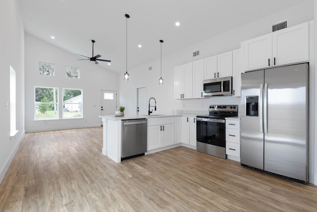 461 S Woodlawn St, Saint Augustine, FL 32084 - kitchen featuring stainless steel appliances, open floor plan, a ceiling fan, a peninsula, and white cabinets