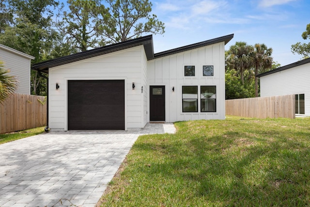461 S Woodlawn St, Saint Augustine, FL 32084 - view of front of house featuring a garage, board and batten siding, and decorative driveway