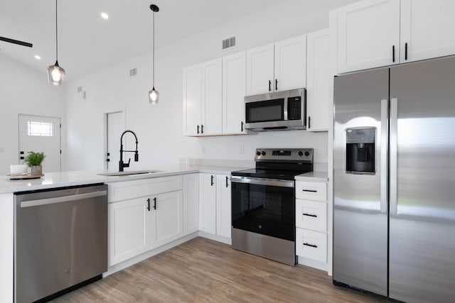 461 S Woodlawn St, Saint Augustine, FL 32084 - kitchen featuring appliances with stainless steel finishes, light countertops, white cabinets, pendant lighting, and recessed lighting