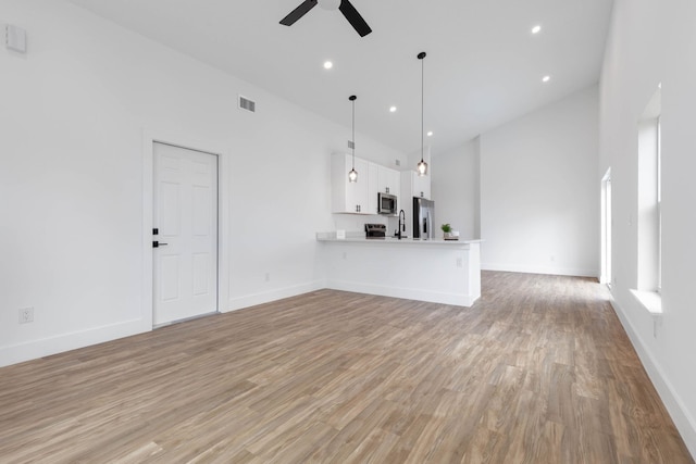 461 S Woodlawn St, Saint Augustine, FL 32084 - unfurnished living room with a ceiling fan, light wood-type flooring, lofted ceiling, and recessed lighting