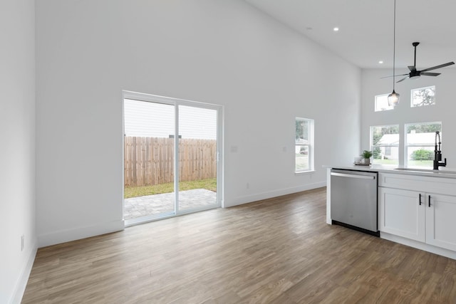461 S Woodlawn St, Saint Augustine, FL 32084 - kitchen with dishwasher, ceiling fan, healthy amount of natural light, white cabinetry, and a high ceiling