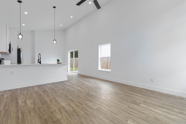 461 S Woodlawn St, Saint Augustine, FL 32084 - unfurnished living room featuring ceiling fan, high vaulted ceiling, recessed lighting, and light wood-style floors