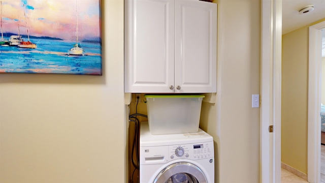 laundry area featuring washer / dryer and cabinet space