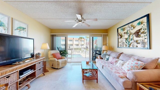 living room featuring a ceiling fan and a textured ceiling