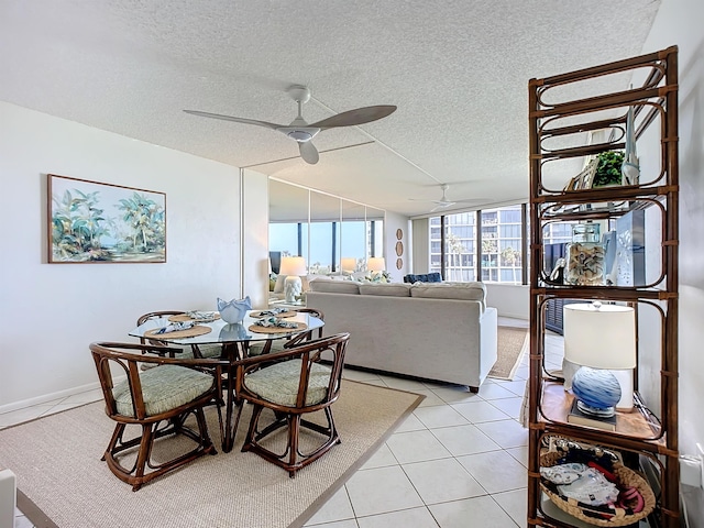 dining space featuring ceiling fan, light tile patterned floors, and a textured ceiling