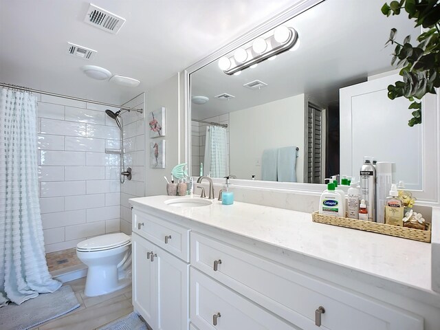 bathroom with tile patterned floors, a shower with curtain, vanity, and toilet