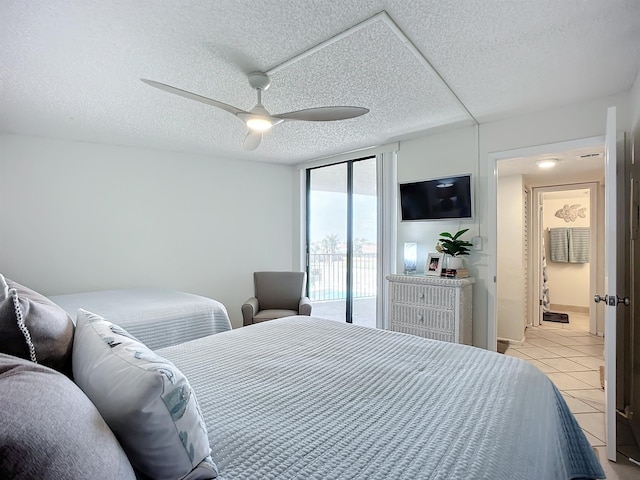 tiled bedroom featuring ceiling fan, a textured ceiling, and access to outside