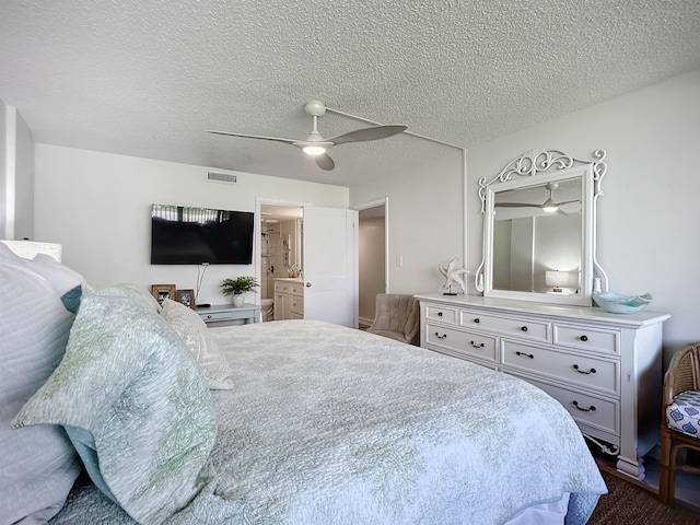 carpeted bedroom with ceiling fan, a textured ceiling, and connected bathroom