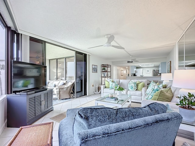 tiled living room featuring a textured ceiling and ceiling fan