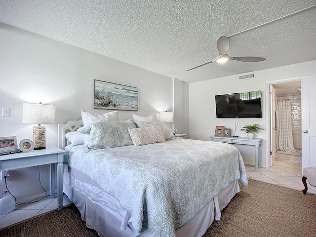 carpeted bedroom featuring ceiling fan, a textured ceiling, and connected bathroom