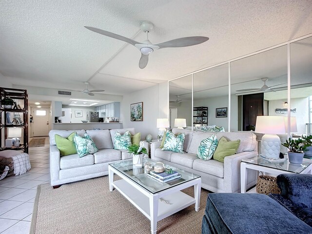 tiled living room featuring a textured ceiling