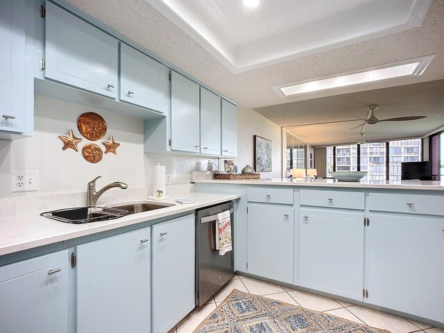 kitchen with a textured ceiling, ceiling fan, sink, light tile patterned floors, and dishwasher