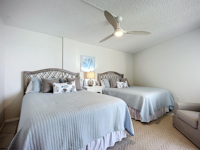 bedroom featuring ceiling fan and a textured ceiling