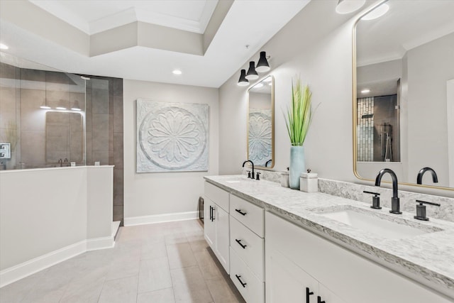 bathroom featuring baseboards, ornamental molding, and a sink