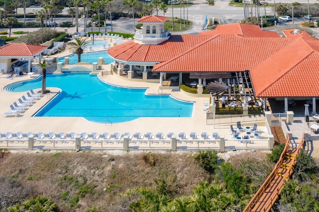 pool featuring fence and a patio