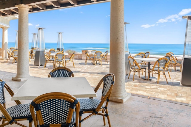 view of patio / terrace featuring a water view and outdoor dining area