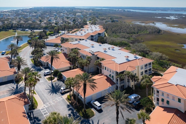 drone / aerial view featuring a water view and a residential view