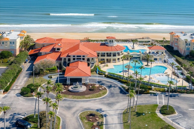 drone / aerial view featuring a water view and a view of the beach