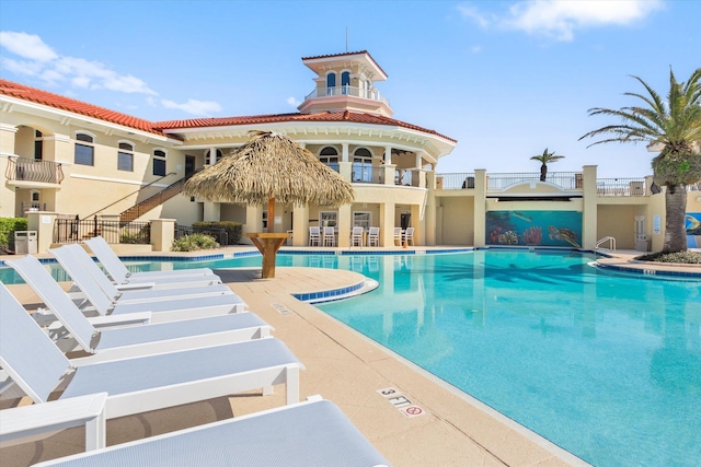 pool with fence and a patio