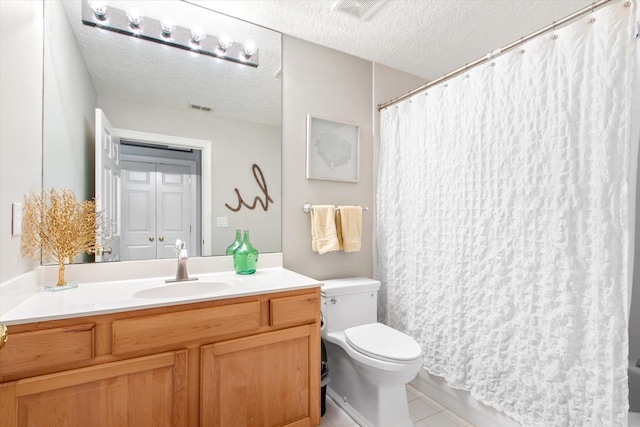 bathroom with toilet, visible vents, a textured ceiling, and vanity