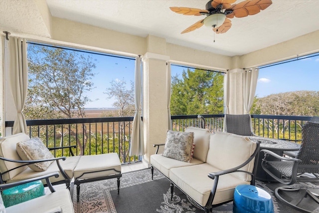 sunroom featuring ceiling fan