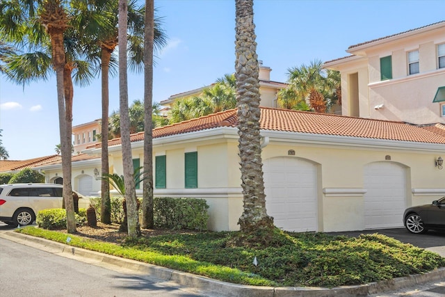 view of side of property featuring a tiled roof and stucco siding