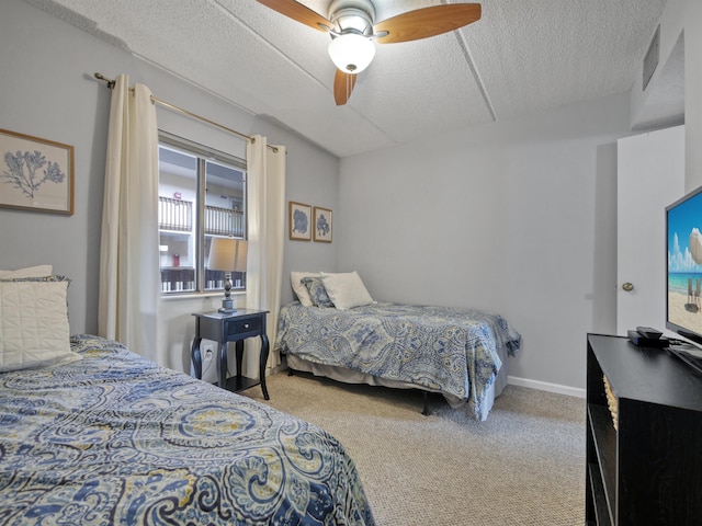 carpeted bedroom with ceiling fan and a textured ceiling