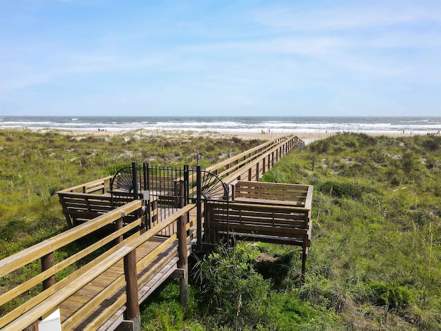 view of property's community featuring a view of the beach and a water view