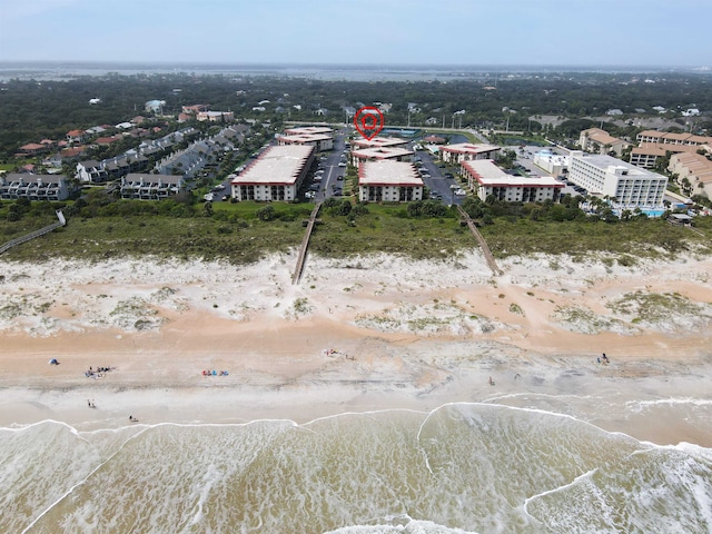 bird's eye view with a water view and a beach view