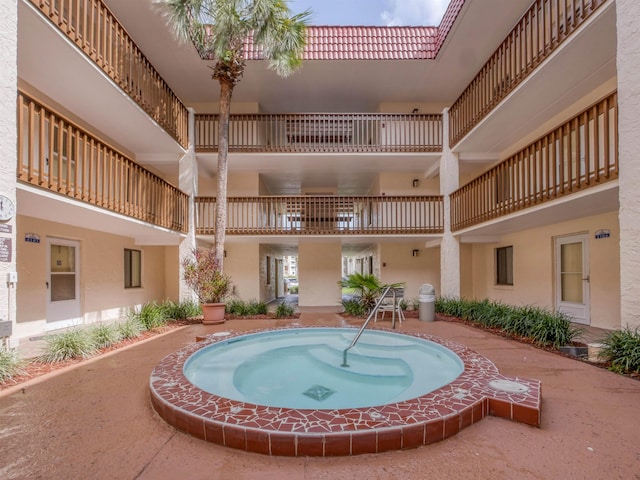 view of swimming pool featuring a hot tub