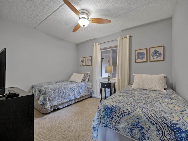 bedroom with carpet flooring, ceiling fan, and a textured ceiling