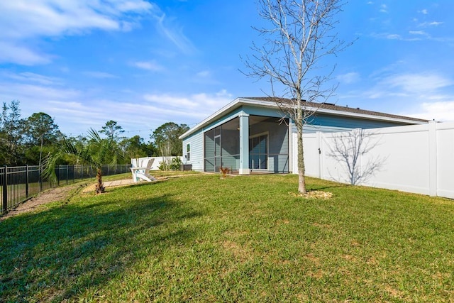 rear view of house featuring a fenced backyard and a lawn