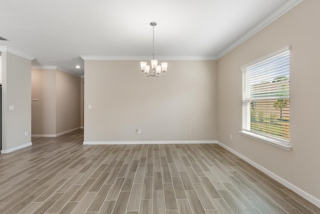 unfurnished room featuring light wood-style floors, crown molding, baseboards, and a notable chandelier