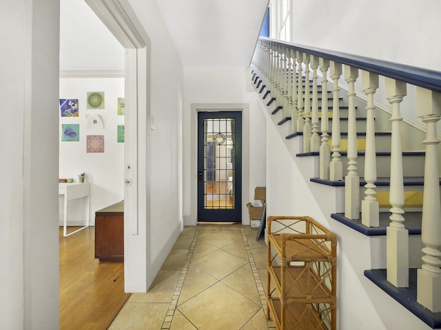 8 Davis St, Saint Augustine, FL 32084 - foyer entrance with baseboards, inlaid floor details, and stairway