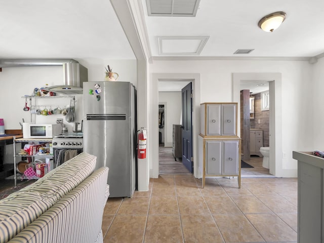 8 Davis St, Saint Augustine, FL 32084 - kitchen featuring appliances with stainless steel finishes, island exhaust hood, and light tile patterned floors
