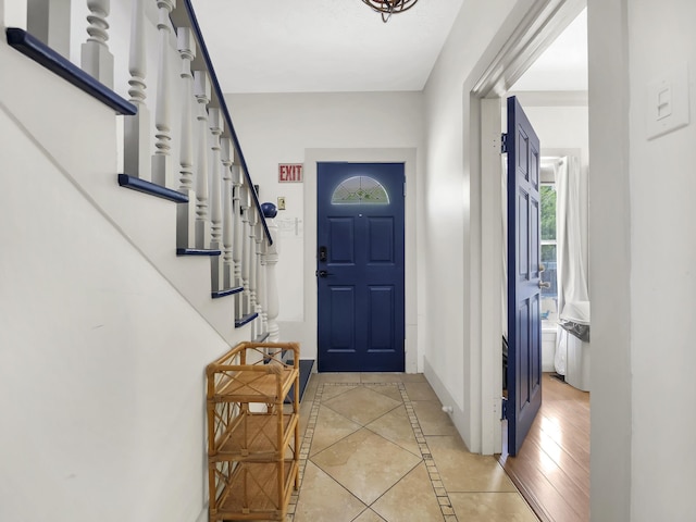 8 Davis St, Saint Augustine, FL 32084 - entryway featuring baseboards, inlaid floor details, stairs, and light tile patterned flooring