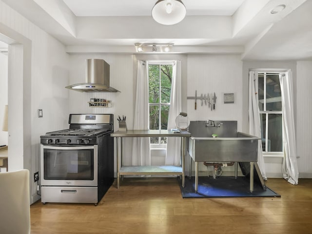 8 Davis St, Saint Augustine, FL 32084 - kitchen with stainless steel range with gas cooktop, island exhaust hood, and wood finished floors