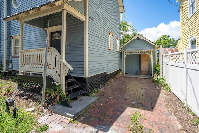 view of side of home featuring an outbuilding