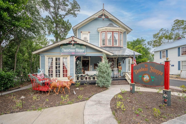 view of front of home with french doors and a porch