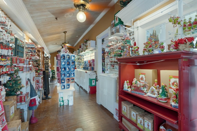 interior space featuring lofted ceiling, dark hardwood / wood-style floors, and ornamental molding