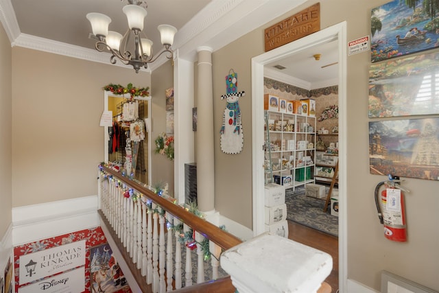 interior space with crown molding, hardwood / wood-style flooring, and a notable chandelier