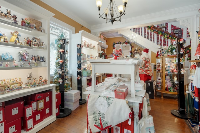 interior space featuring a chandelier, hardwood / wood-style floors, and ornamental molding