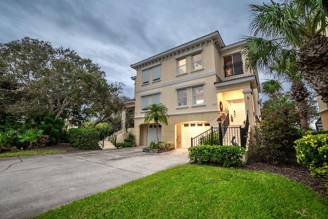 view of front of property featuring a balcony and a garage