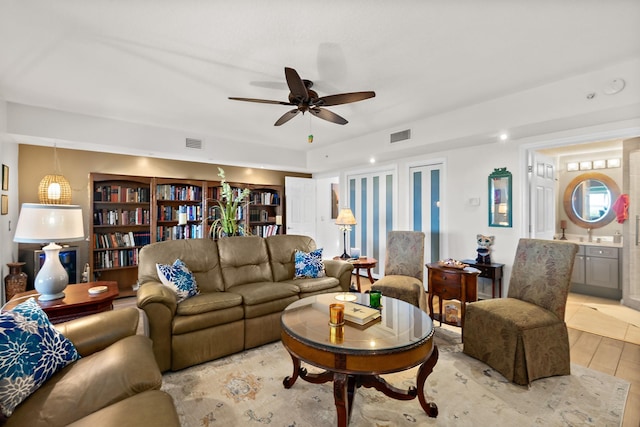 living room featuring light wood-type flooring and ceiling fan